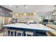 Spacious kitchen featuring a large island, modern appliances, custom cabinets, and designer lighting at 8478 Elba Isle Ct, Windermere, FL 34786