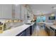 Gourmet kitchen featuring white countertops, custom cabinetry, and stainless steel appliances at 8478 Elba Isle Ct, Windermere, FL 34786