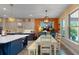 Eat-in kitchen boasts custom cabinetry, a central island, and a dining area with large windows at 8478 Elba Isle Ct, Windermere, FL 34786