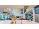 Bright, open-concept living room featuring a modern kitchen, high ceilings, and starburst pendant lights at 8478 Elba Isle Ct, Windermere, FL 34786
