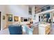 Bright living room featuring a soaring ceiling, second-floor balcony and built-in shelving for storage and display at 8478 Elba Isle Ct, Windermere, FL 34786
