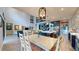 Living and dining area offers a view of a modern staircase and a large island with stainless steel appliances at 8478 Elba Isle Ct, Windermere, FL 34786