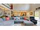 Open concept living space with view to large sectional sofa, kitchen with island, and staircase at 8478 Elba Isle Ct, Windermere, FL 34786