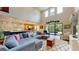 Open-concept living room with high ceilings, expansive windows, comfortable seating, and adjacent kitchen and dining areas at 8478 Elba Isle Ct, Windermere, FL 34786