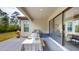 Covered outdoor dining area with a grill, table, and sliding glass doors to the indoor space at 8478 Elba Isle Ct, Windermere, FL 34786