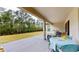 Covered patio featuring outdoor dining area with a view of the backyard and mature trees at 8478 Elba Isle Ct, Windermere, FL 34786