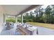 Covered patio featuring outdoor dining area with a view of the backyard with mature trees at 8478 Elba Isle Ct, Windermere, FL 34786