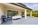 Enjoy outdoor gatherings on the covered patio with scenic backyard views and grill at 8478 Elba Isle Ct, Windermere, FL 34786