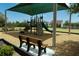 Community playground with slides and climbing features is sheltered by a canopy at 8478 Elba Isle Ct, Windermere, FL 34786