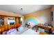 This playroom features a rainbow painted wall, a bookcase, and plenty of space for activities at 8478 Elba Isle Ct, Windermere, FL 34786