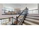 Beautiful staircase with dark wood railings leading to an open loft area, connecting multiple levels at 8478 Elba Isle Ct, Windermere, FL 34786