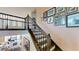 Elegant staircase with dark wood railings and trim, complemented by Gathering photos on the wall at 8478 Elba Isle Ct, Windermere, FL 34786