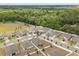 A serene aerial view highlights the spacious lots of the homes and nearby forested area at 849 Avenal Ln, Davenport, FL 33837