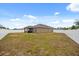 Expansive backyard featuring a covered patio and a full privacy fence at 849 Avenal Ln, Davenport, FL 33837