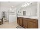 Bathroom with double sink vanity, glass enclosed shower and large mirror at 849 Avenal Ln, Davenport, FL 33837