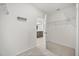 Walk-in closet with access to a bathroom and multiple shelving at 849 Avenal Ln, Davenport, FL 33837