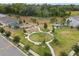 Aerial view of a community park with a playground, walking paths, and picnic areas at 849 Avenal Ln, Davenport, FL 33837