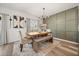 Dining area featuring a rustic wood table, decorative lighting, and stylish accents at 849 Avenal Ln, Davenport, FL 33837