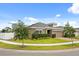 Well-manicured lawn surrounds this home with tidy landscaping and neutral colored exterior at 849 Avenal Ln, Davenport, FL 33837