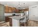 Well-appointed kitchen featuring granite countertops, stainless steel appliances, and an island with seating at 849 Avenal Ln, Davenport, FL 33837