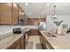 Modern kitchen featuring granite countertops, stainless steel appliances, and ample cabinet space at 849 Avenal Ln, Davenport, FL 33837