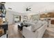 Comfortable open-concept living room showcasing stylish decor and seamless access to the kitchen and dining areas at 849 Avenal Ln, Davenport, FL 33837