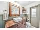 Charming bathroom featuring a vessel sink, wood-framed mirror, and stylish fixtures at 8619 Veridian Dr, Orlando, FL 32810