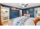 Comfortable primary bedroom with blue accent wall, an ensuite bathroom and walk-in closet at 8619 Veridian Dr, Orlando, FL 32810