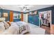 Bedroom with blue walls, ceiling fan, window and closet with storage system at 8619 Veridian Dr, Orlando, FL 32810