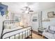 Lovely bedroom with metal frame bed, a crib, natural light and ceiling fan at 8619 Veridian Dr, Orlando, FL 32810
