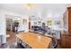 Open dining area with a wooden table and chairs, connecting to the living room and kitchen at 8619 Veridian Dr, Orlando, FL 32810