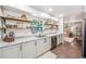 Modern kitchen with granite countertops, stainless steel appliances, and open shelving at 8619 Veridian Dr, Orlando, FL 32810