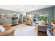Open living room with a large area rug, slider to backyard, and view of the kitchen at 8619 Veridian Dr, Orlando, FL 32810