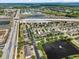 An aerial view of townhomes in a neighborhood with a beautiful fountain lake, and highway in the distance at 9009 Savannah Julip Ln, Orlando, FL 32832