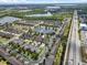 An aerial view shows a townhome community with water features and attractive landscaping in a desirable location at 9009 Savannah Julip Ln, Orlando, FL 32832
