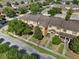 An aerial view showcases this neighborhood's charming townhomes, lush landscaping, and a peaceful community setting at 9009 Savannah Julip Ln, Orlando, FL 32832