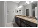 Modern bathroom with granite countertop, dark wood cabinets and double sinks at 9009 Savannah Julip Ln, Orlando, FL 32832