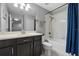 Bathroom with dark wood cabinets, double vanity, and shower-tub combination at 9009 Savannah Julip Ln, Orlando, FL 32832