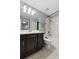 Bathroom with dark wood cabinets, double vanity, and shower-tub combination at 9009 Savannah Julip Ln, Orlando, FL 32832