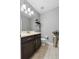 Stylish bathroom with dark vanity, modern mirror, decor, and neutral color scheme at 9009 Savannah Julip Ln, Orlando, FL 32832