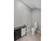 Functional bathroom space with toilet, toiletries storage, and tile flooring at 9009 Savannah Julip Ln, Orlando, FL 32832