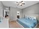 Bright bedroom with grey walls, carpet floors, ceiling fan and bathroom access at 9009 Savannah Julip Ln, Orlando, FL 32832