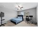 Comfortable bedroom with a ceiling fan and a well lit desk area at 9009 Savannah Julip Ln, Orlando, FL 32832