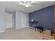 This is a cozy room with a blue accent wall, ceiling fan, and two storage closets at 9009 Savannah Julip Ln, Orlando, FL 32832