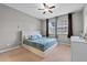Well-lit bedroom features a ceiling fan, carpet floors, and a large window at 9009 Savannah Julip Ln, Orlando, FL 32832