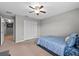 Bright bedroom with closet access, neutral carpet, and ceiling fan at 9009 Savannah Julip Ln, Orlando, FL 32832