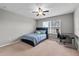 Bedroom with desk, chair, ceiling fan, window and carpeted floor at 9009 Savannah Julip Ln, Orlando, FL 32832