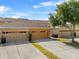 Inviting townhome with well-manicured lawn, spacious driveway, and attached garage, exuding curb appeal at 9009 Savannah Julip Ln, Orlando, FL 32832