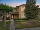 Charming townhome boasts lush landscaping, inviting entrance, and classic architectural details at 9009 Savannah Julip Ln, Orlando, FL 32832