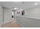 This is an upstairs hallway with a view to the downstairs entry of the house at 9009 Savannah Julip Ln, Orlando, FL 32832